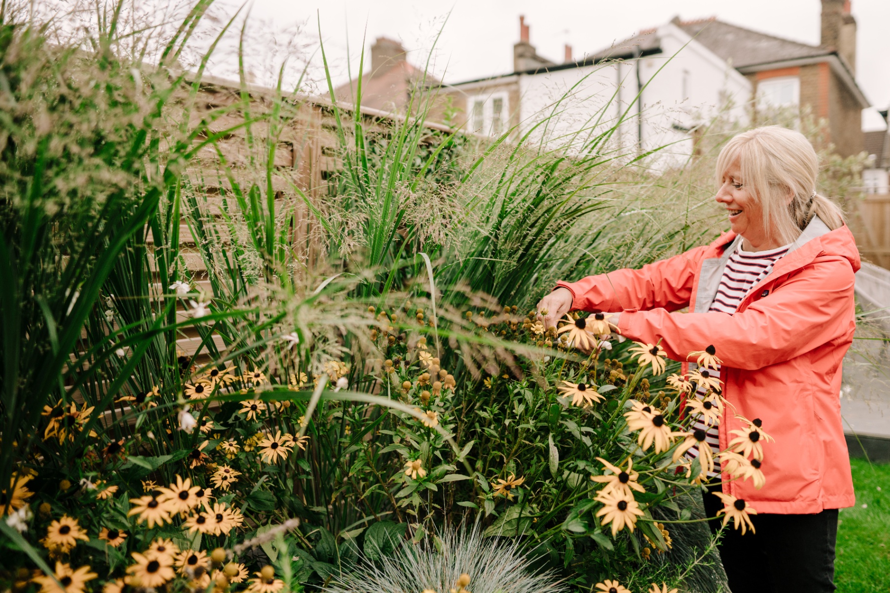 Woman gardening, smiling
