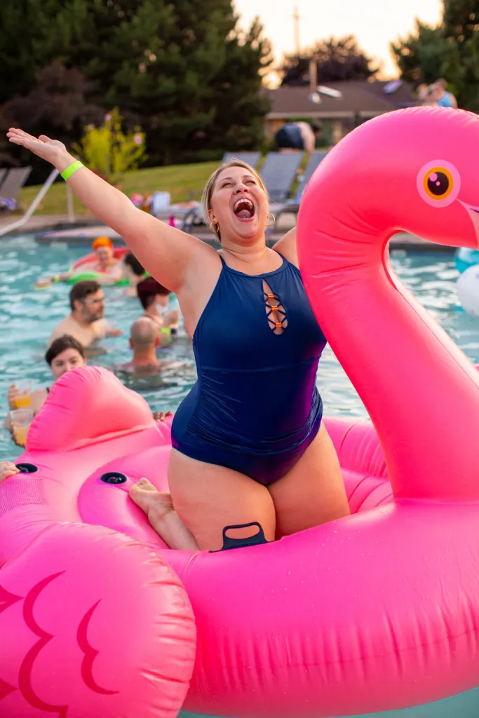 Woman laughing joyfully on a pool float